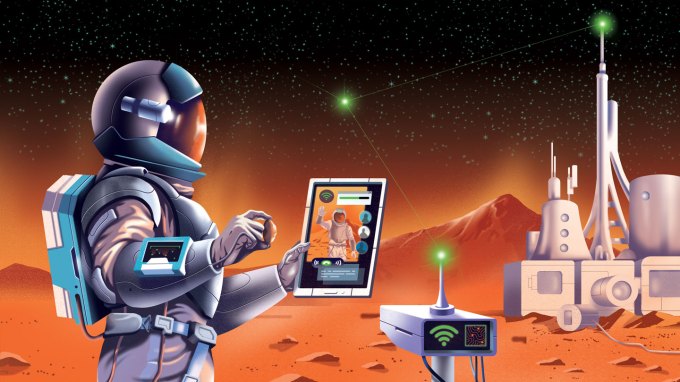 An astronaut on Mars looks at a tablet device with the Red Planet landscape, base station and rover in the background